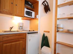 uma pequena cozinha com um lavatório e um micro-ondas em Studio Flaine, 1 pièce, 4 personnes - FR-1-687-73 em Arâches-la-Frasse