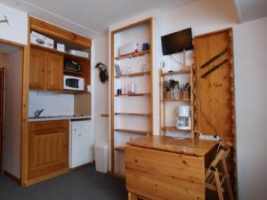 a kitchen with wooden cabinets and a wooden desk at Studio Flaine, 1 pièce, 4 personnes - FR-1-687-73 in Arâches-la-Frasse