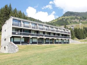 a large building on a hill with a green field at Studio Flaine, 1 pièce, 4 personnes - FR-1-687-73 in Arâches-la-Frasse