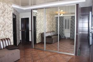 ノヴォシビルスクにあるApartamenty Svetlica Koshurnikova 5のリビングルーム(ガラス張りの部屋、ソファ付)
