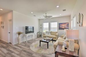 a living room with a couch and a tv at Bright and Breezy Galveston Retreat with Deck! in Galveston