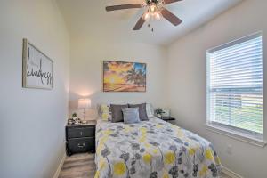 a bedroom with a bed and a ceiling fan at Bright and Breezy Galveston Retreat with Deck! in Galveston