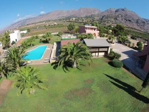 an aerial view of a house with a pool and palm trees at Kallicrates Village in Frangokastello
