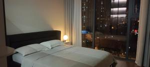 a bedroom with a bed and a window with a city at Full House - The Matrix One in Hanoi +76 photos