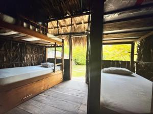 a bedroom with two bunk beds in a house at Mistica Island Hostel - Isla Palma in Isla Palma