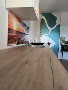een keuken met een houten aanrecht en een wastafel bij ADC in Sibiu
