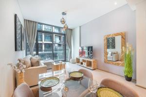 a living room with a couch and a table at Modern flat with KING SIZE bed and HIGH SPEED Wifi in Dubai