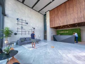 a man playing a video game in a living room at Modern flat with KING SIZE bed and HIGH SPEED Wifi in Dubai