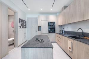 a kitchen with a sink and a counter top at Modern flat with KING SIZE bed and HIGH SPEED Wifi in Dubai