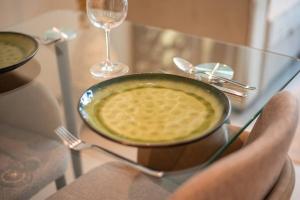 a table with a plate of food and a wine glass at Modern flat with KING SIZE bed and HIGH SPEED Wifi in Dubai