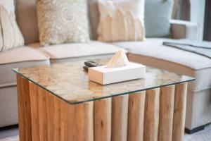 a coffee table in a living room with a couch at Modern flat with KING SIZE bed and HIGH SPEED Wifi in Dubai