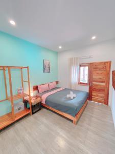 a bedroom with a large bed and a mirror at LANGCHIA HOME in Phu Quoc