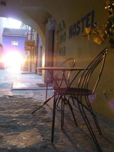 a chair and a table in front of a building at Old Town Kanonia Hostel & Apartments in Warsaw