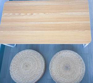 two baskets are sitting under a wooden table at Yeongjongdo high floor Ocean View in Incheon
