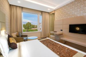 a hotel room with a bed and a flat screen tv at Lariya Resort in Jodhpur