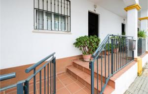 a staircase in a house with a black door and plants at Stunning Home In La Algaba With 3 Bedrooms in La Algaba