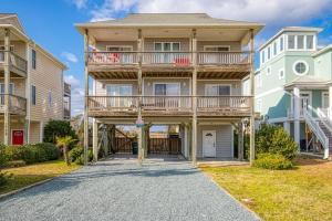 a large apartment building with a balcony and a driveway at Double Blessing in North Topsail Beach