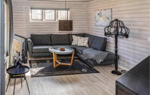 a living room with a couch and a table at Nice Home In Ödeshög With Wifi in Ödeshög