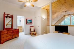 a bedroom with a bed and a dresser and a mirror at Mountain Retreat in Conway