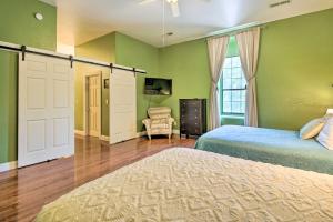 a bedroom with green walls and a bed and a window at Spacious Springfield Apt Less Than 4 Mi to Downtown! in Springfield