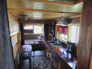 a kitchen with a counter and a sink in a train at La loma del chivo Llc Stone Cottage alternative building in Marathon