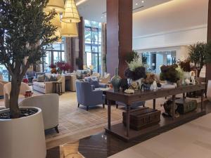 a lobby with a table with plants on it at Address Beach Resort Residence Fujairah in Fujairah