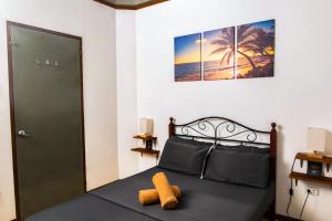 a bedroom with a bed with a green door at Ohlala Hostel in Moalboal