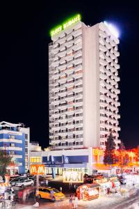 a hotel building with a sign on top of it at Kuban Resort & Aquapark - All Inclusive in Sunny Beach