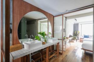 a bathroom with two sinks and a mirror at GalileOasis Boutique Hotel in Bangkok