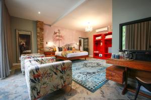 a large living room with a bed and a couch at Droombos Boutique Hotel in Windhoek