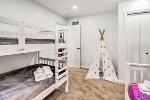 a bedroom with two bunk beds and a christmas tree at Pocono Summit Family Paradise with Yard and Game Room! in Pocono Summit Estates
