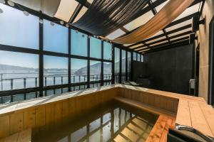 an indoor swimming pool in a building with windows at Louis Boutique Hotel in Changwon