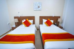Ένα ή περισσότερα κρεβάτια σε δωμάτιο στο La Villa Hotel