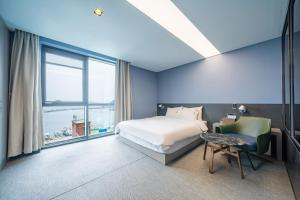 a bedroom with a bed and a large window at Louis Boutique Hotel in Changwon +66 photos
