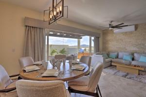 a dining room and living room with a table and chairs at Luxe Cabo Casa w/ Own Rooftop Patio + Pool Access! in Cabo San Lucas