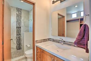 a bathroom with a sink and a toilet and a mirror at Luxe Cabo Casa w/ Own Rooftop Patio + Pool Access! in Cabo San Lucas +22 photos