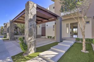 a rendering of a house with a stone pillar at Luxe Cabo Casa w/ Own Rooftop Patio + Pool Access! in Cabo San Lucas