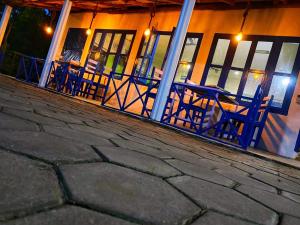 a group of blue chairs sitting outside of a building at Hotel Butterfly , Sauraha , Chitwan in Sauraha
