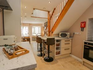 a kitchen with a counter and a kitchen island at Endgill Cottage in Ulverston
