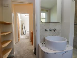 a bathroom with a white sink and a mirror at Endgill Cottage in Ulverston +22 photos