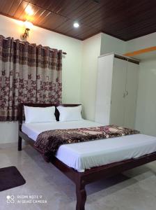 Postel nebo postele na pokoji v ubytování Cauvery Homestay