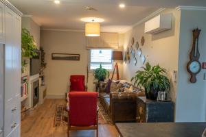 a living room with a couch and a chair at Laneway Apartments in Napier