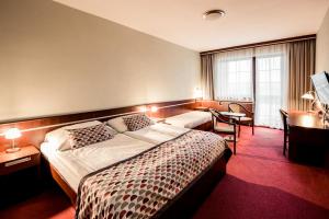 Postel nebo postele na pokoji v ubytování OREA Resort Panorama Moravský kras