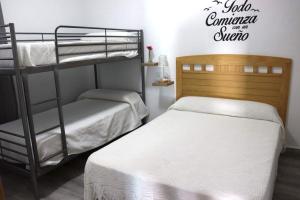 1 dormitorio con 2 literas y un cartel que lee el club de verano. en Apartamento “Las Cuadras “, en Cádiz