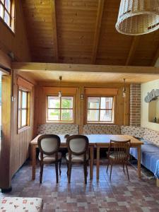 a dining room with a wooden table and chairs at Penzion Petra in Telč