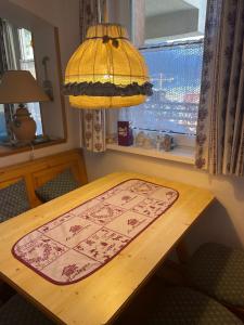 a table with a rug on it in a room with a window at Bella Stubai in Fulpmes