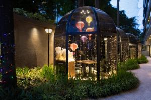 a gazebo with a table in it with lights at Oakwood Suites Kuningan Jakarta in Jakarta