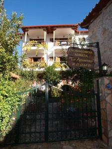 a gate in front of a building with a sign at Arhontiko in Psarádes