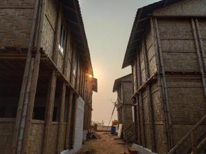 an alley in an old building with the sun setting at Chivarin Resorts in Malvan
