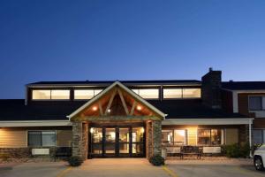 a house with a front door with lights at AmericInn by Wyndham Aberdeen Event Center in Aberdeen